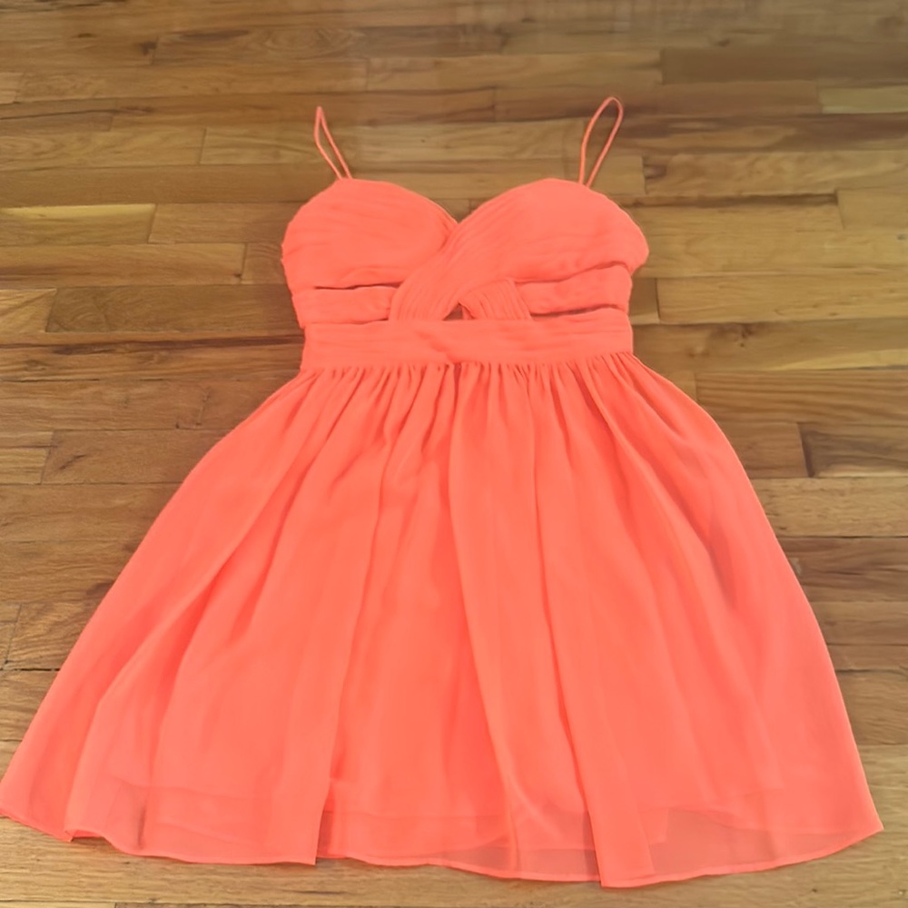 Light flowy dress with open design on front and back with material.